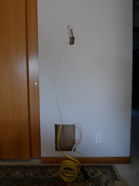 Holes in wall, with wires coming out of them, during upgrade to low-voltage thermostat.
